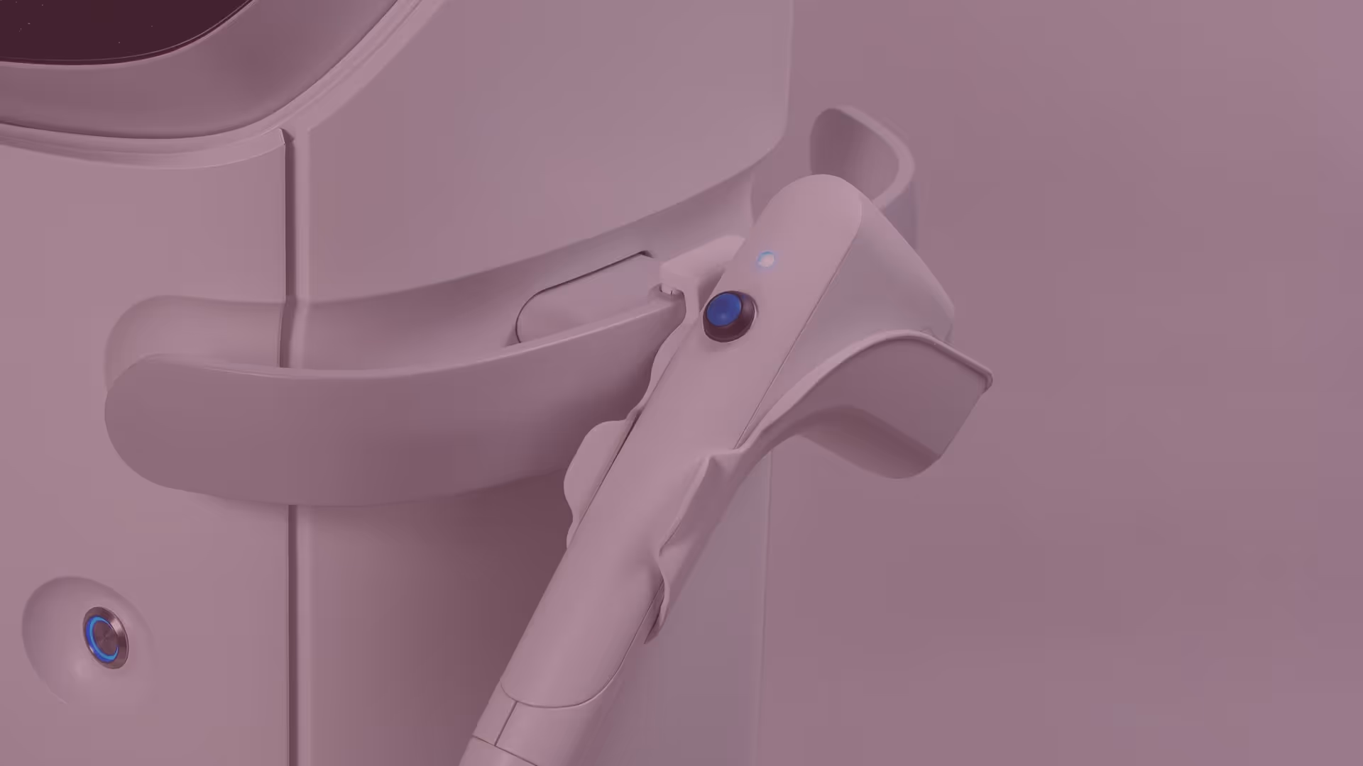 Close-up of a white handheld device with a blue button resting in a wall-mounted holder.